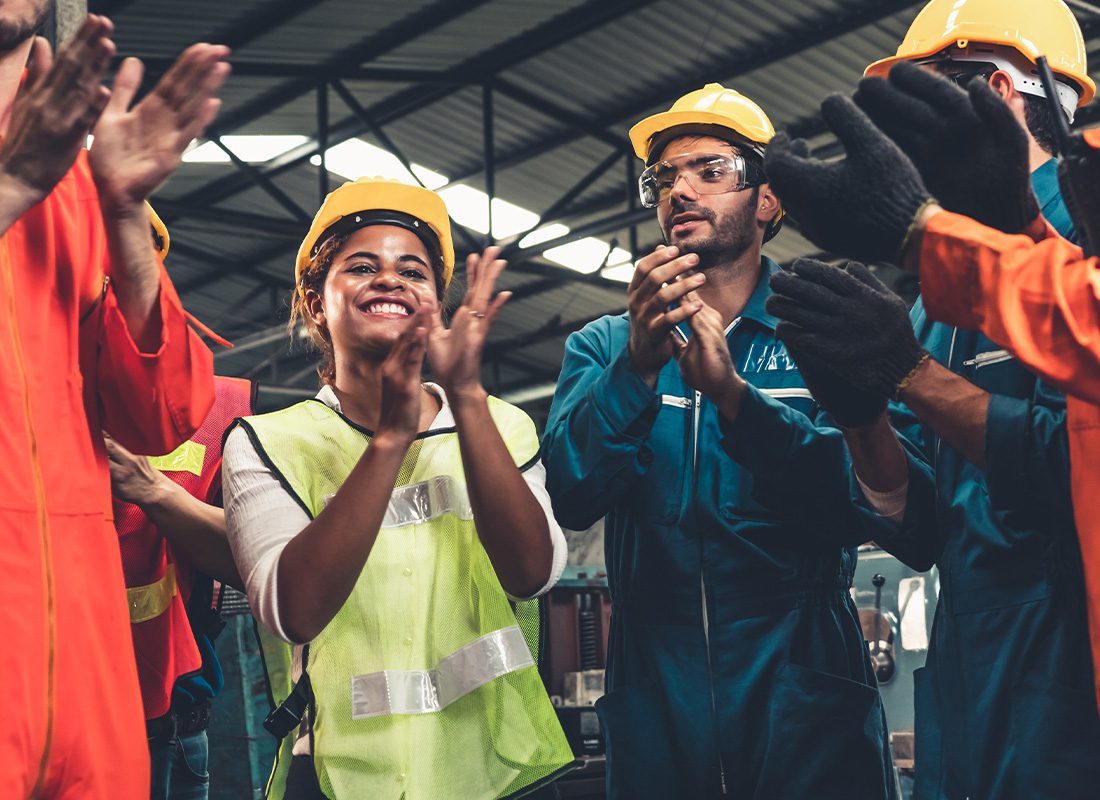 Insurance by Industry - Skillful Workers Celebrate Success in a Manufacturing Labor Factory